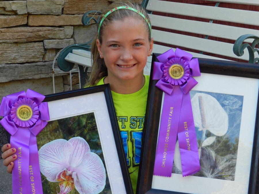 Laura+Lockard%2C+a+sixth-grade+student+at+Warrensburg+Middle+School%2C+displays+her+Best+of+Show+awards+from+the+Chilhowee+Fall+Fair+Fine+Arts+Competition.+She+earned+Best+of+Show+in+both+Youth+Under+17+Photography+and+Youth+Under+17+Art.+A+trip+to+Powell+Gardens+provided+the+subject+matter+for+her+charcoal+drawing+and+photo.