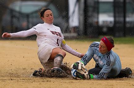 (Photo by Andrew Mather, digitalBURG) Kayla Shain, left, slides for the ball in the Jennies 3-0 shutout over Southwestern Oklahoma Sunday.