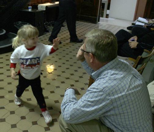 (Photo by Andy Lyons, digitalBURG) State Sen. David Pearce gets a victory high-five from a little supporter, Mallory Hall, at the Johnson County Courthouse Tuesday night.