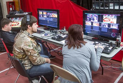 (Photo by Andrew Mather, digitalBURG) From left, UCM students Dusty Likins, Adam Buchheit and Melissa Conger work the TriCaster board during a basketball game.