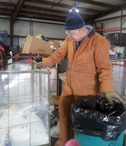 (Photo by Alexandra Lambdin) A Johnson County Sheltered Workshop employee sorts recyclable materials. The workshop now accepts glass.