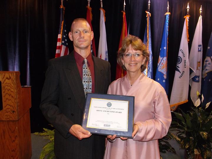 Master Sergeant Darryl Smithson and Warrensburg City Manager Paula Hertwig Hopkins with the Above and Beyond Award presented to the City of Warrensburg on August 23.