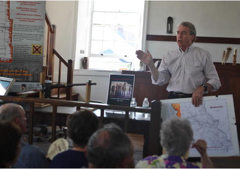 By Faith Slaughter
Tom Rafiner, 67, presents a program based on his book “Cinders and Silence: A Chronicle of Missouri’s Burnt District, 1854 – 1870,” Sunday at The Johnson County Historical Society’s annual membership meeting. Rafiner is a researcher, historian and author from Raytown Mo.