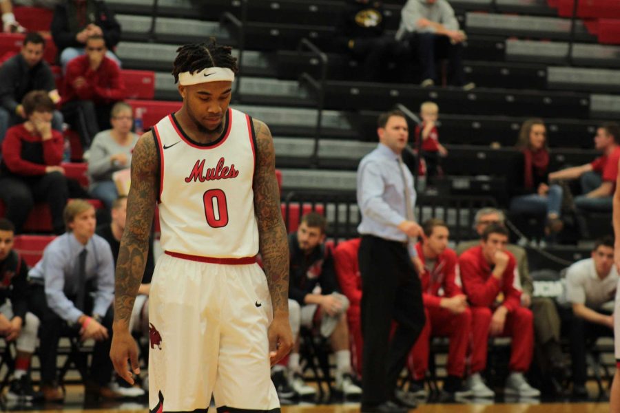DMarnier Cunningham, 0, looks down during a break in action against Fort Hays State University. The Mules lost to the Tigers 69-68. PHOTO BY ALEX AGUEROS