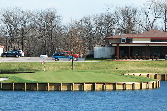 PHOTO BY BRANDON BOWMAN / PHOTO EDITOR
Overlooking the Audrey J. Walton Clubhouse and Traditions Restaurant, the 18th green of Keth Memorial Golf Course is surrounded entirely by water to challenge golfers.
