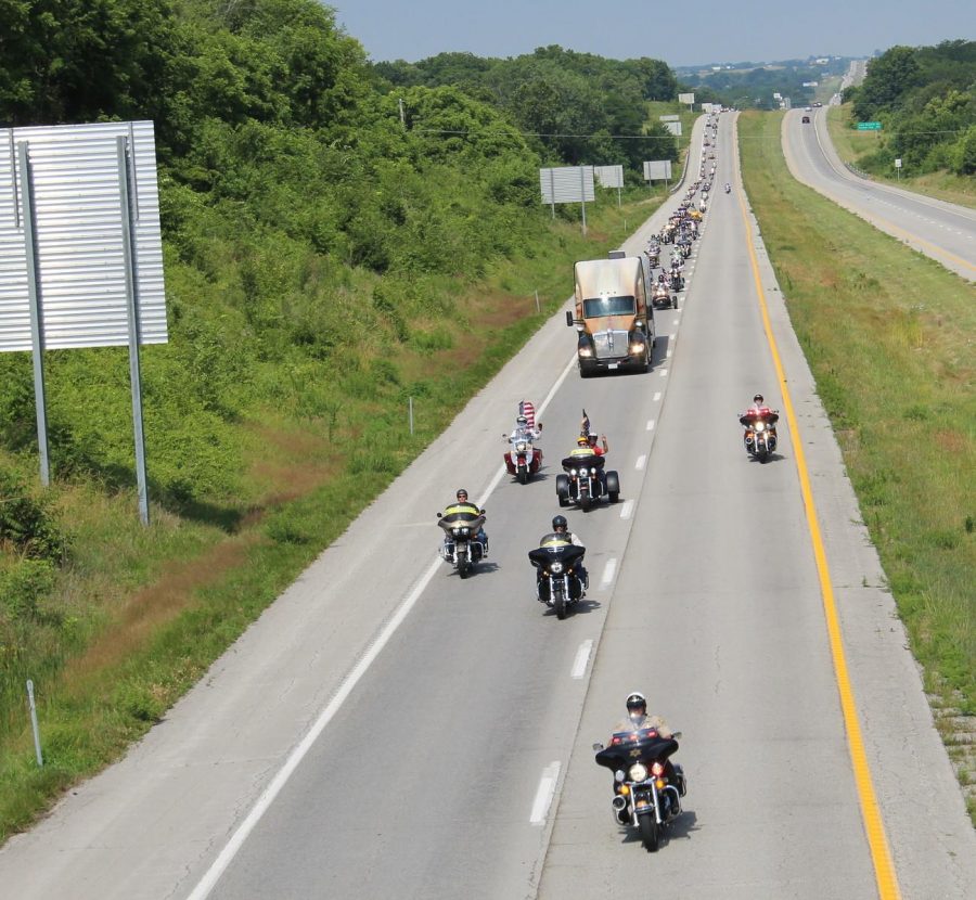 Submitted by Jane Heavin
A line of sheriff's department officials from Jackson County, Mo., and Johnson County, Mo., along with the Lee's Summit Motorcycle Police Squadron, the Warrensburg Police Department, UCM Police, and American Legion and Patriot Guard motorcycle riders escort the Wall That Heals into Warrensburg along U.S. 50 Tuesday. The UCM McClure Archives and University Museum will host The Wall That Heals, a mobile half-scale replica of the Vietnam Veterans Memorial, in Washington, D.C., from June 29-July 2 on the lawn along the west side of the James C. Kirkpatrick Library. The exhibit is a program of the Vietnam Veterans Memorial Fund, the founders of the Vietnam Veterans Memorial. The exhibit includes a mobile Education Center and features photos of service members whose names are on The Wall, a timeline of the Vietnam era, and letters and memorabilia left at The Wall in D.C. The Wall That Heals will be open 24 hours a day during its stay in Warrensburg.