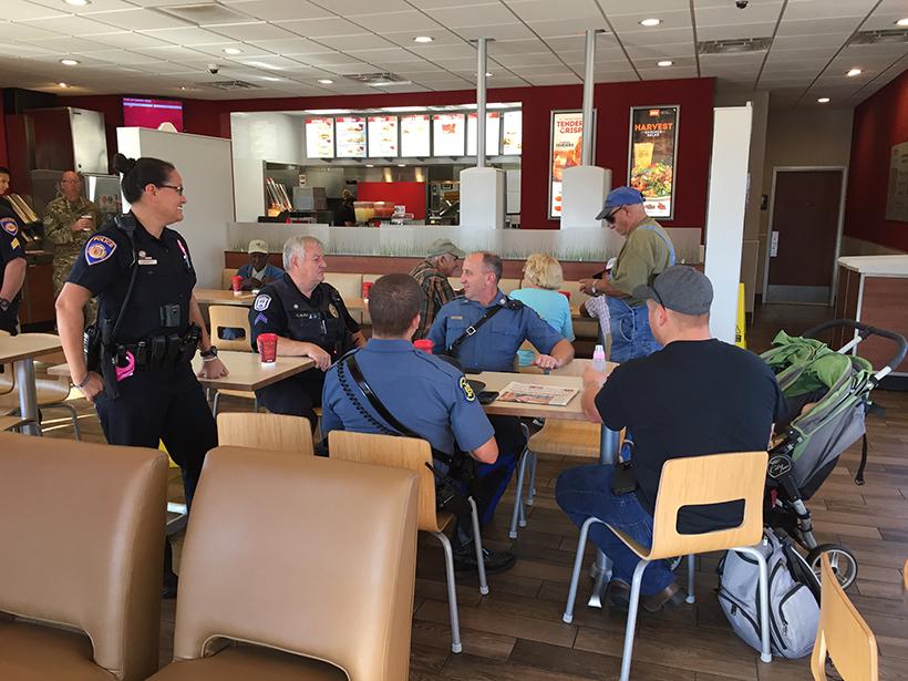 Law enforcement officials from UCM Public Safety, the Warrensburg Police Department, Missouri State Highway Patrol and Whiteman Air Force Base sit Wednesday with a community member talking about different topics.
(Photo by Erin Wides/Features Editor)