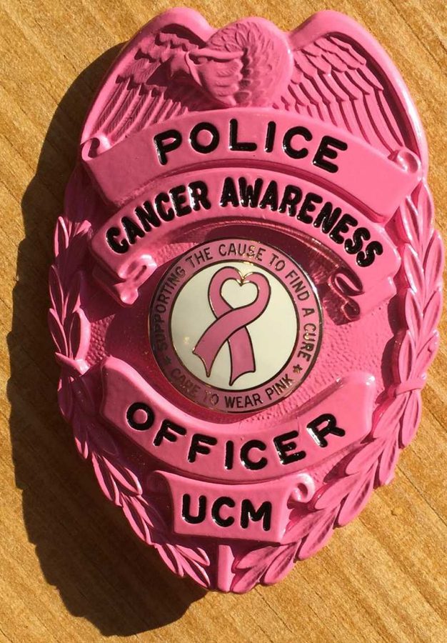 Some Public Safety officers purchased pink badges to wear in October in support of Breast Cancer Awareness month. The inner pin reads, “Supporting the cause to find a cure. Care to wear pink.”
(Photo by Erin Wides/Features Editor)
