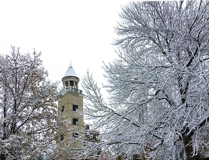 The Maastricht Friendship Tower behind stands behind the trees in Selmo Park Friday. According to the National Weather Service in Pleasant Hill, Missouri, about 5 1/2 inches of snow fell Thursday night in Warrensburg. (Photo by Erica Oliver / Asst. Photo Editor)