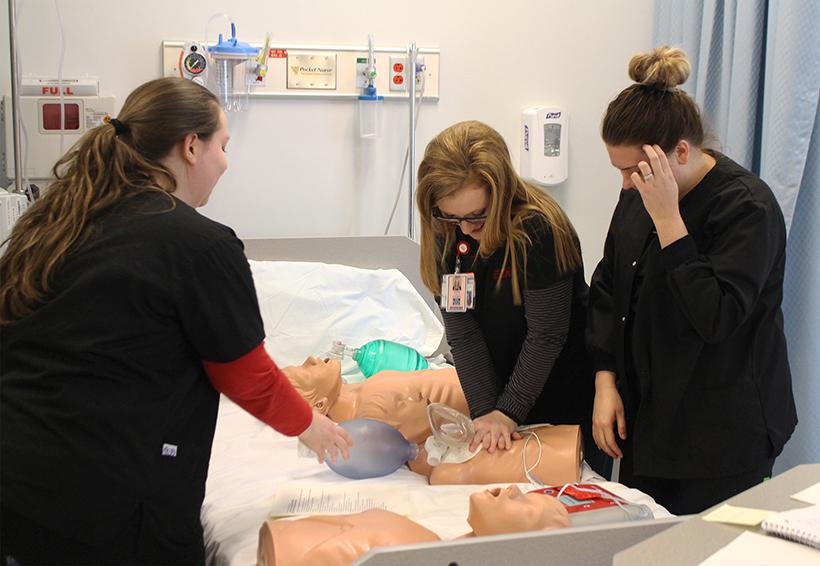 Nursing students Hailey Seeley and Courtney Hawley practicing CPR and using Automated External Defibrillator (AED). (Photo by Erin Wides/ Features Editor)
