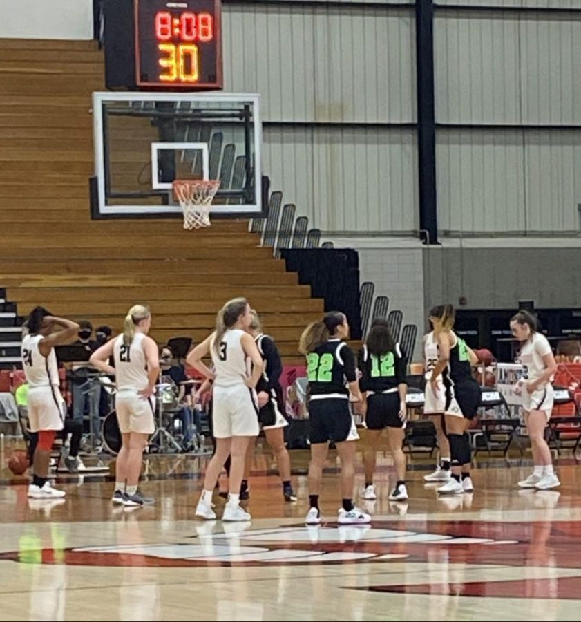 The Jennies start lining up as the Riverhawks set to make a free throw because of the foul against the Jennies.