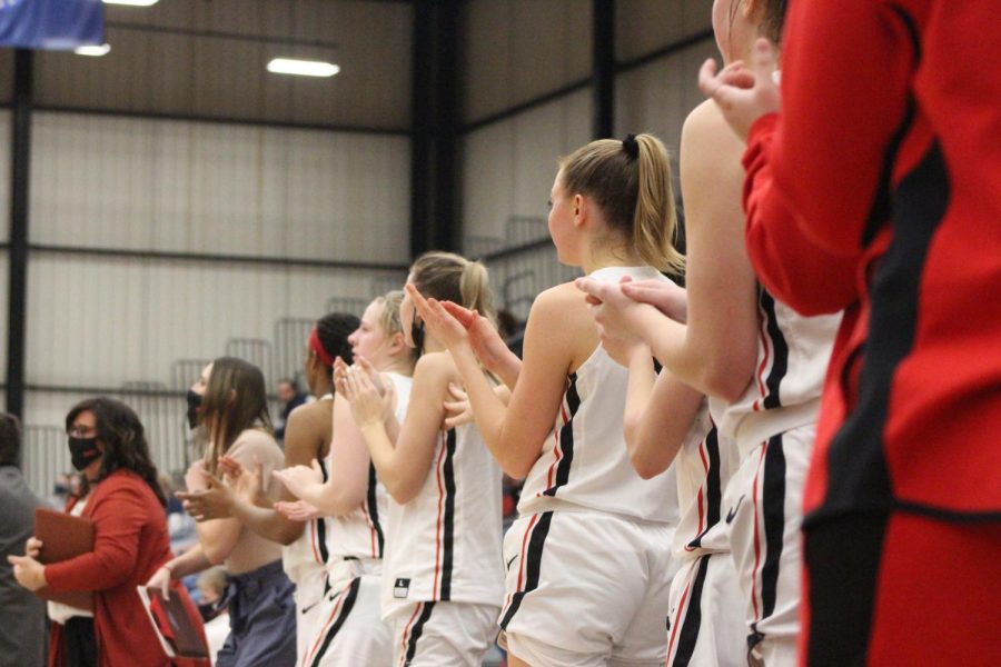 The team cheers on their teammates from the sidelines. Photo by Emily Dickmeier

