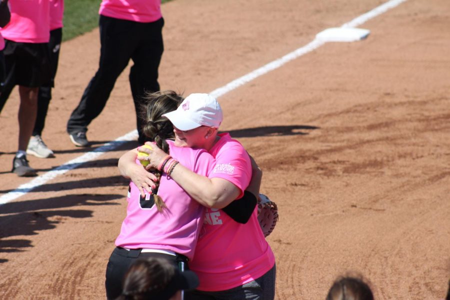 At the first ceremonial pitch, Michelle threw the ball to Northeastern player, freshman catcher Vic Leslie. Leslie’s mother has also been battling breast cancer. After the toss, they hugged to show support for each other. 