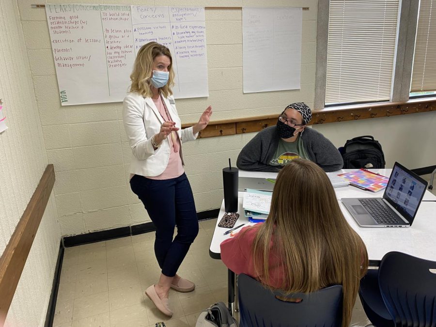 Karrie Snider, associate professor of early childhood education, works with some of her students on a class activity.