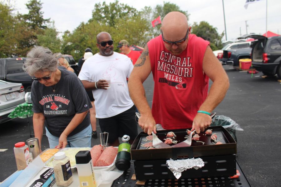 Kurt Sunderman flattens the burgers with two spatulas as he makes stack burgers. "I've had such a great time doing this," Sunderman said. "I've met life-long friends and all these people are now my extended, and it's just a lot of fun." 