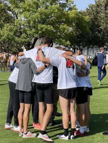 The men’s cross country team huddles together before competing in the MIAA cross country championship in Kearney Ne. on Oct. 23, 2021. 