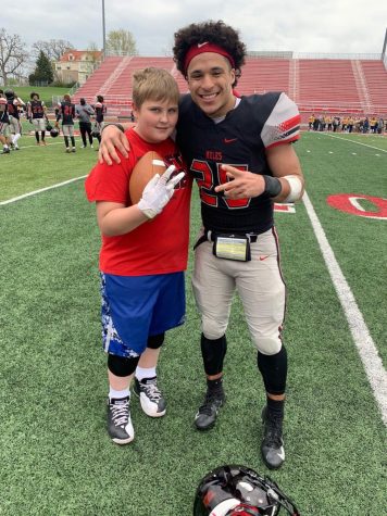 Sophomore Christian Davis of the UCM Football team poses with his little. 