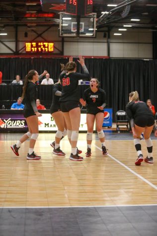 The volleyball team celebrates after a rally point.