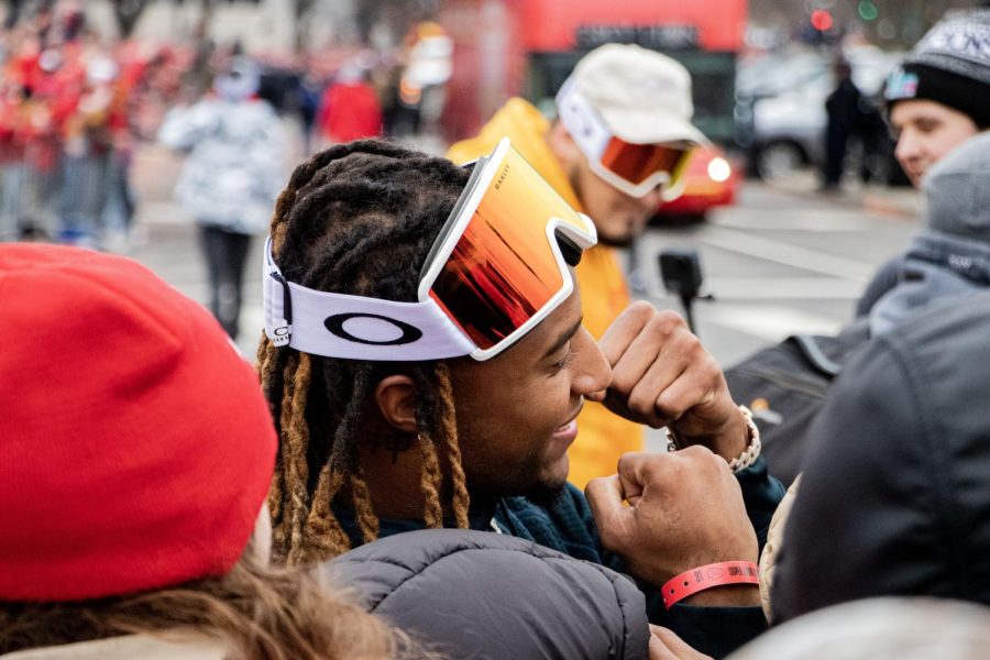At the Victory parade on Feb. 15 Kansas City Chiefs Saftey Justin Reid is taking photos with fans. Reid
is celebrating with the fans after winning the 2023 Superbowl.