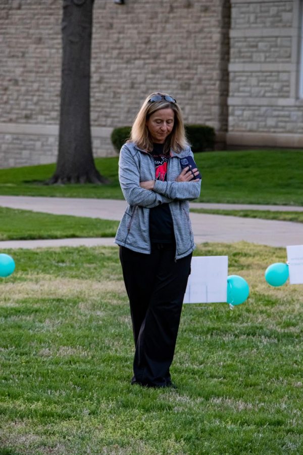 Betsy Kreisel, a criminal justice faculty member and associate dean for the Harmon College of Business and Professional Studies, takes a moment of silence at the Shine a Light event.