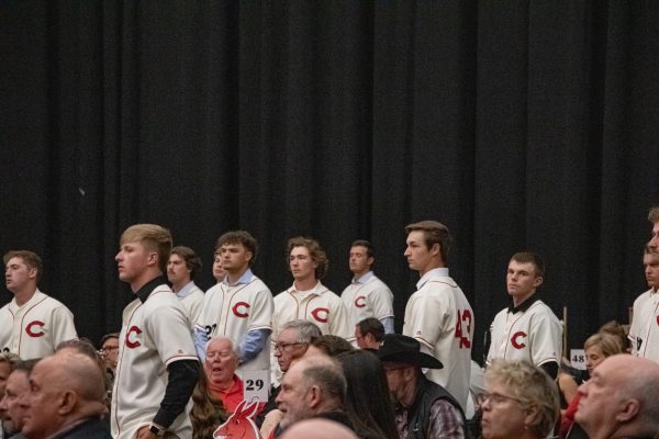 Current Mules players stand while being recognized at the First Pitch banquet on Mar. 23. During the banquet, they heard from speakers who talked about how to persevere on and off the field and outside of college. 
