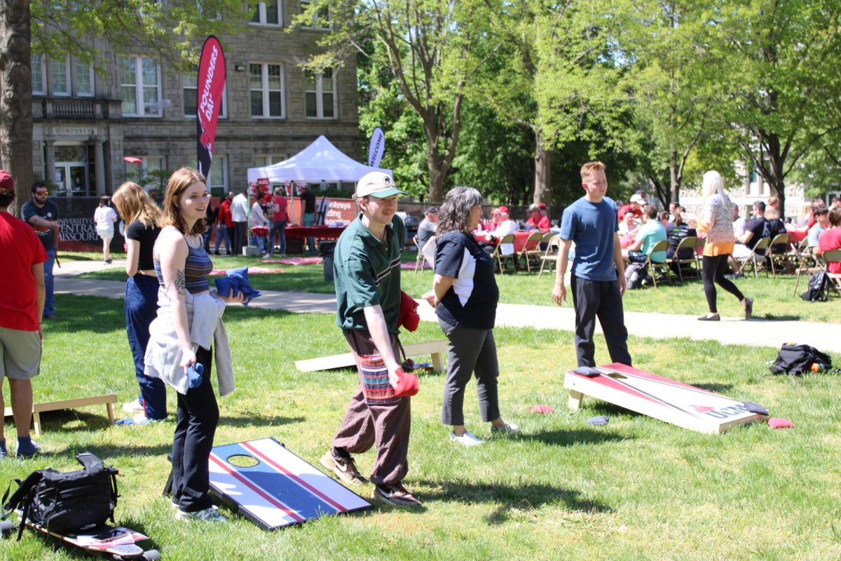 Students participate in corn hole at the UCM Founders Day Birthday Bash. There were a variety of yard games at the event for students to take part in.