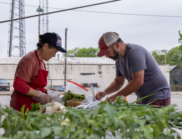 Potential customers peruse the stalls at the Warrensburg Farmers Market. The farmers market, held at 300 N. Holden St. operates from 8:00 AM to 12:00 PM Saturdays from May to the end of Sept. Photo Submitted by Warrensburg Convention and Visitors Bureau