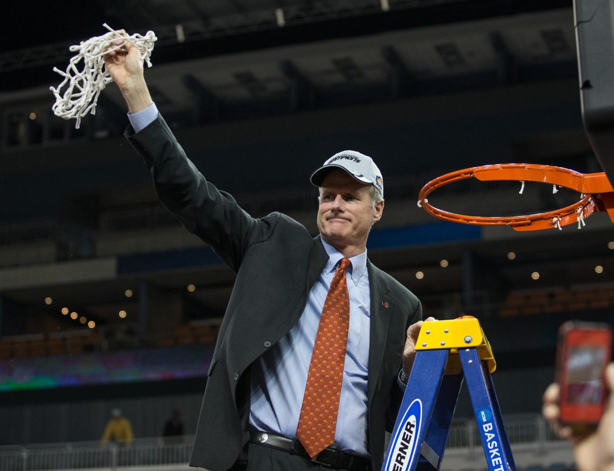 Former Basketball Coach Kim Anderson is showing the cut basketball net in the 2014 National Championship of the NCAA Division II Basketball Tournament. After winning the game, the whole team cuts a small strip of the net to keep. Submitted photo by UCM Athletics.