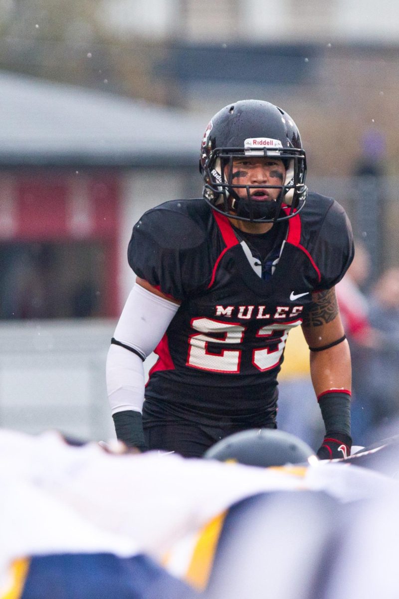 Former Mules Football player Brett Grinn prepares for the snap during a game at Audrey J. Walton Stadium in 2012. Grinn attended UCM from 2007 to 2012, earning a MBA in finance. 