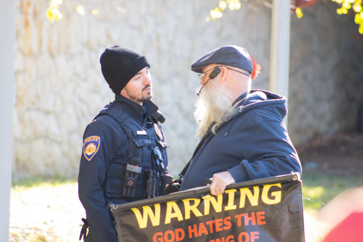 University of Central Missouri Public Safety officer Davis Johnson (left) speaks with demonstrator Jeffrey Mullen (right) during Mullen’s speech on Nov. 20 at 12:54 p.m. in the Union Mall. During Mullen’s time on the UCM campus, public safety officers like Johnson kept a close eye on the situation, ensuring everyone was safe.