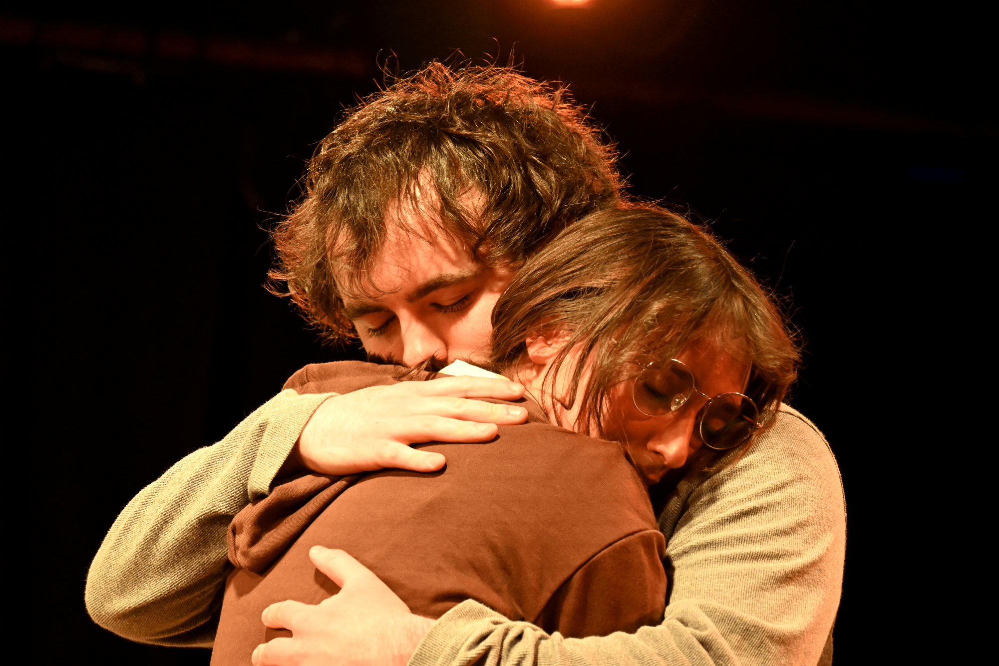 (Left) Art, played by freshman Ayden Christensen, and (right) Gal, played by junior Hannah Vath, embrace in the one act “F#king Art”. This was one of four one-acts part of the Feb. 6-8 Divi- sion of Theater and Dance “Love(Im)Perfectly” series.