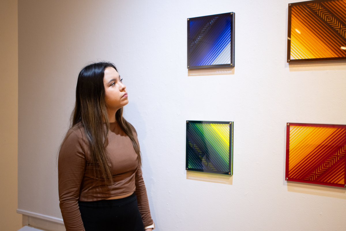 Sophomore Linda Alviar gazes at “Serapes in Space” by Kansas City-based independent creative consultant Edwing Mendez. The piece was a part of the “Lost and Found” exhibition on display at the University of Central Missouri’s Art Gallery highlighting the experiences of Latino-American artists exploring their identity and heritage.