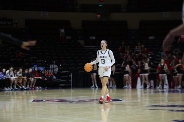 Lauren Frost dribbles the ball at mid-court for the Jennies. Frost would record a double double with 14 points and 10 assists on the night. 