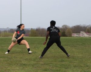 Women's rugby player Alexis Jaggie prepares to pass the ball during practice while Henoc Nsingi readies to intercept the play. The women's rugby team was founded in 2011 and is a walk-on sport.