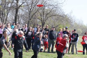 University of Central Missouri alumni, volunteers, project coordinators and community members throw frisbee discs at the opening of the Blaine Whitworth Disc Golf Course. The event was on April 12 and was open to the public. 