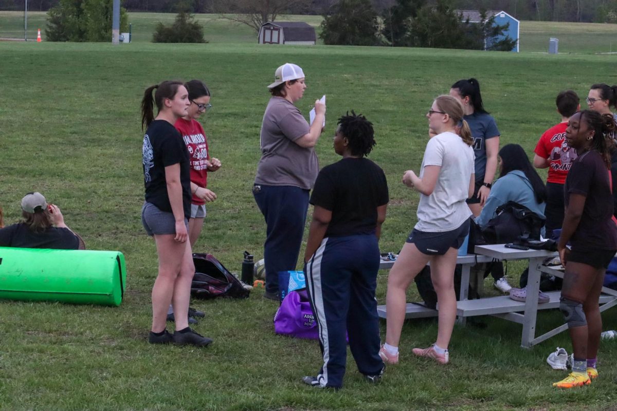 (Middle) Head Coach Aspen Mohr gives the team a rundown of what their practice will look like today. The team went over different types of interceptions and liftings, where the team lifts players up to gain an advantage when competing for the ball in lineouts.