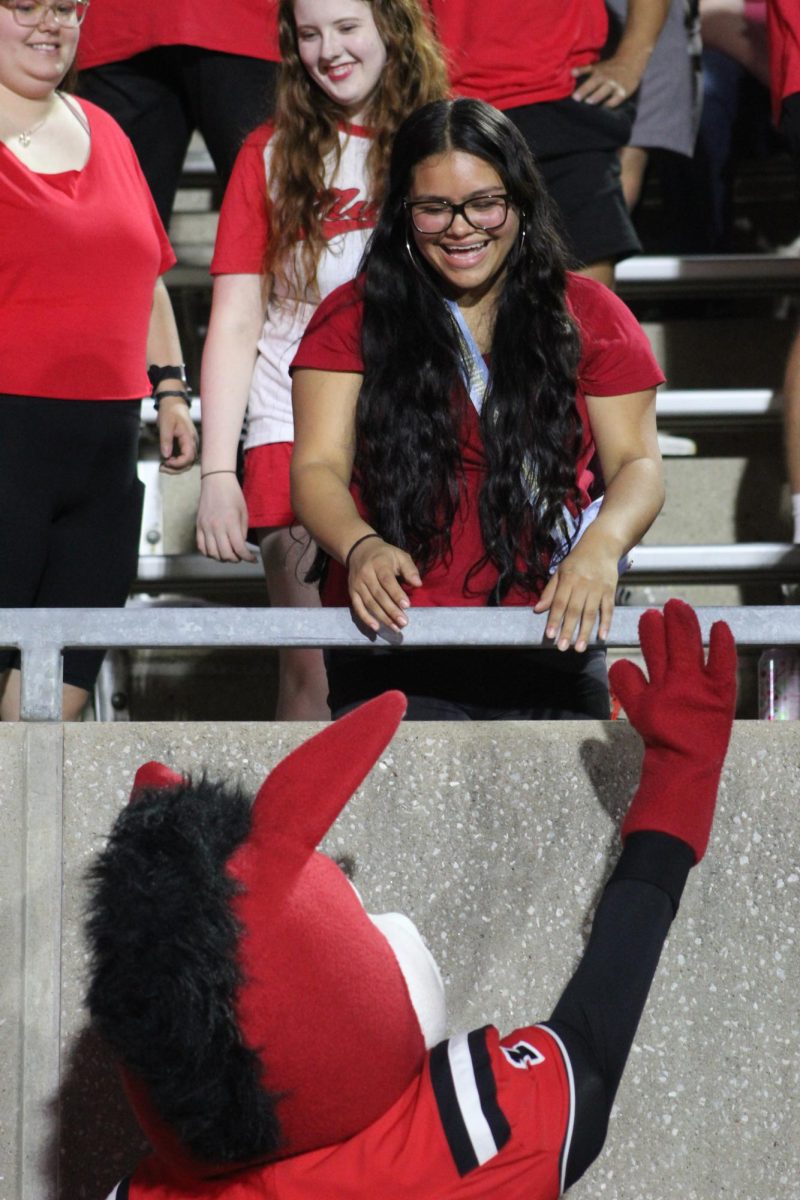 Mo the Mule and a UCM student high-five at UCM’s first home football game on Sept. 11 at the Audrey J. Walton Stadium. Two student workers, a sophomore and a junior, represent UCM’s mascot.