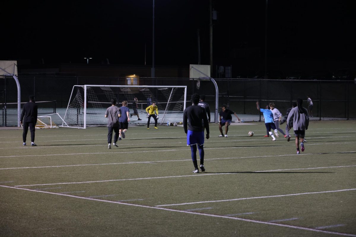 A group of male soccer players participate in a pick-up game of soccer at Ellis Field. The pick-up games typically occur every Tuesday and Thursday at 6:30 p.m.