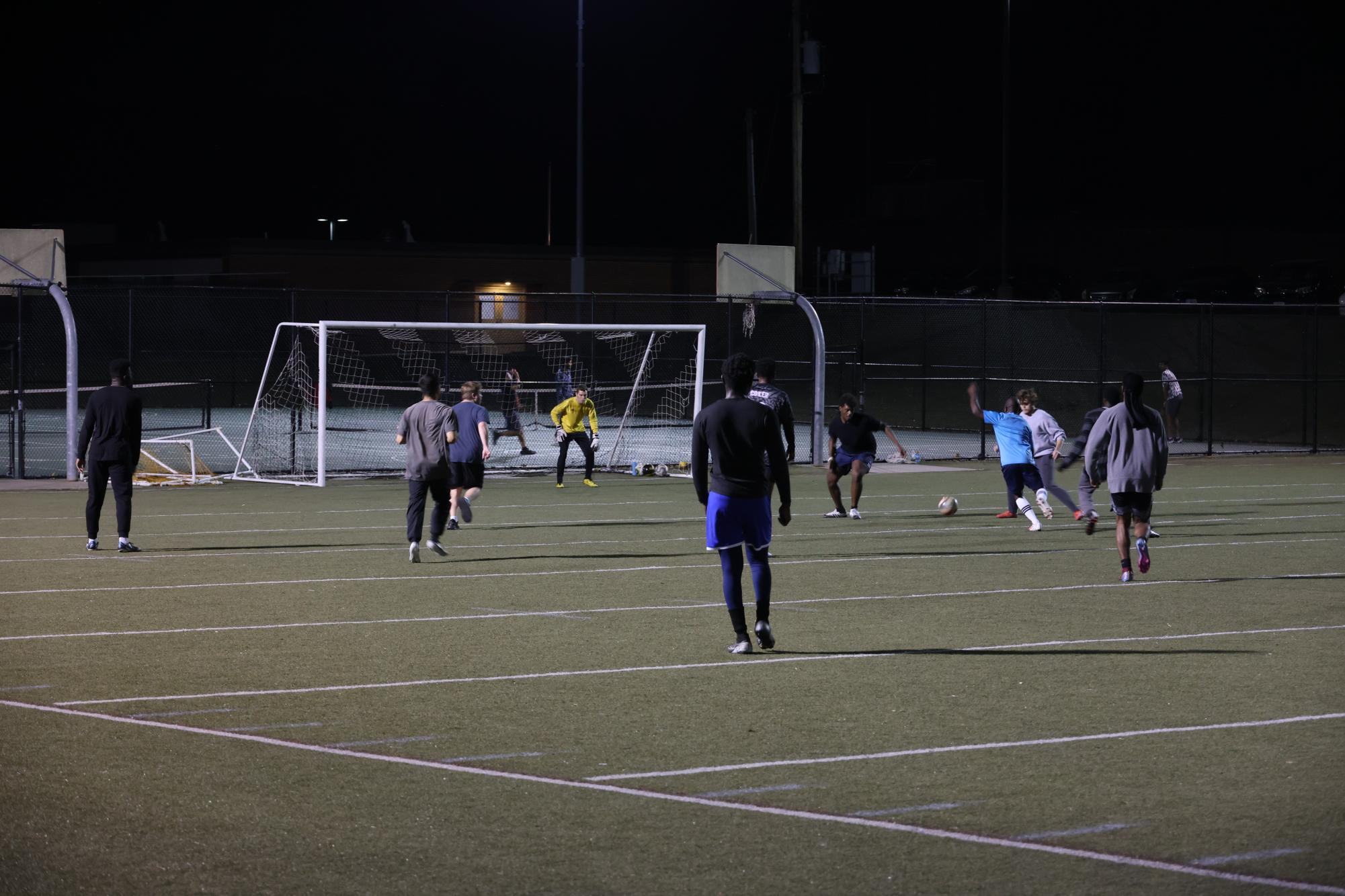 A group of male soccer players participate in a pick-up game of soccer at Ellis Field. The pick-up games typically occur every Tuesday and Thursday at 6:30 p.m.