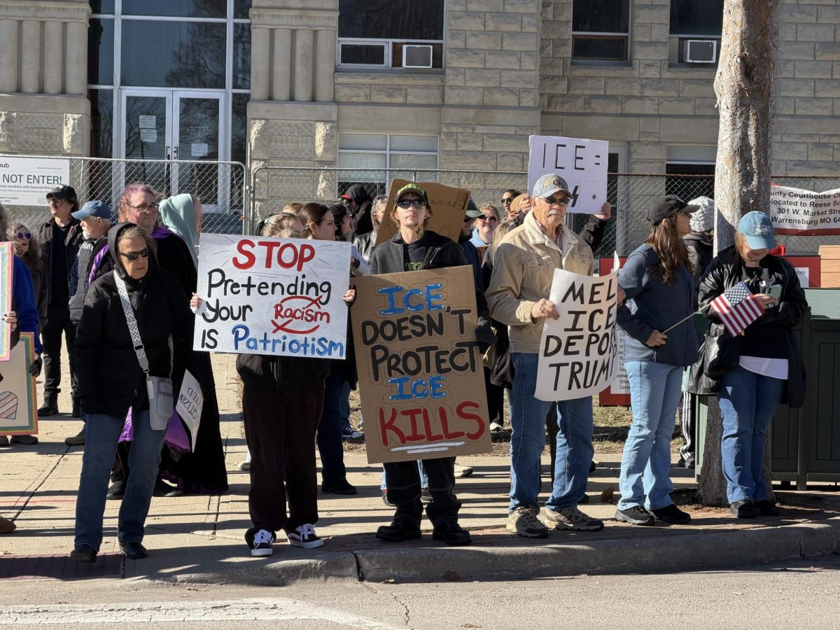 Protesters stand outside the Johnson County Courthouse voicing their dissatisfaction with the Trump administration and the death of Renee Nicole Good. The protest was held on Jan. 10 at noon.