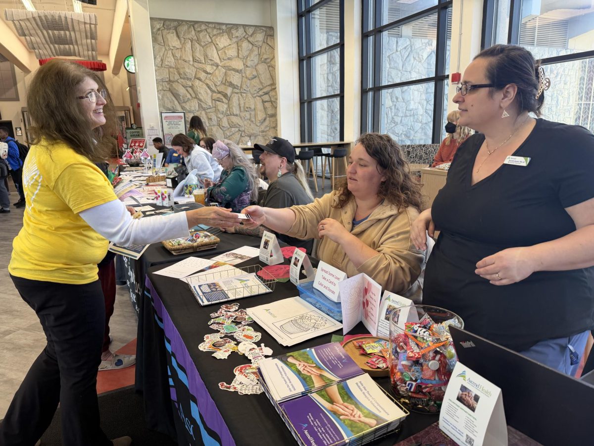 Representatives from Ascend Health provide information about their organization at the volunteer fair on Jan. 21. 19 volunteer organizations were present in the Elliott Student Union.