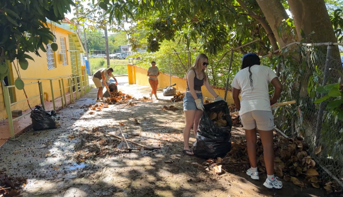 Students from the University of Central Missouri clean up leaves and trash outside of a nonprofit called “For Such a Time as This” on March 13 in Aguada, Puerto Rico. Students also volunteered at a food pantry, elderly center, and center for women and children.